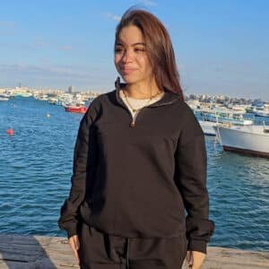 Adult wearing black quarter zip French Terry sweatshirt